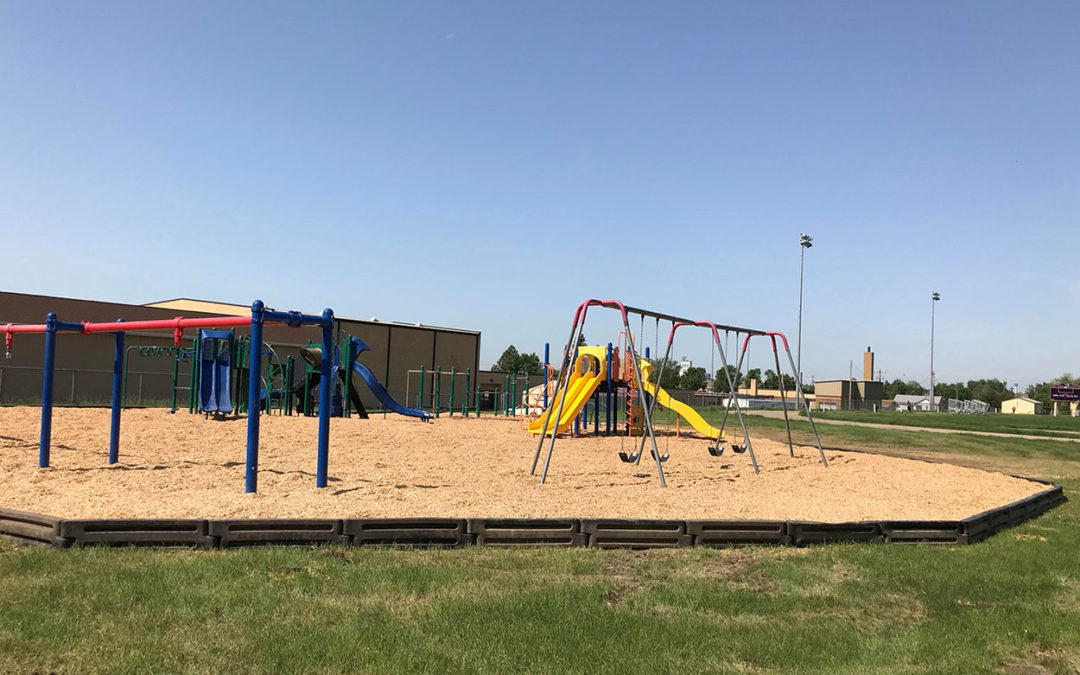 Side view of playground and swings