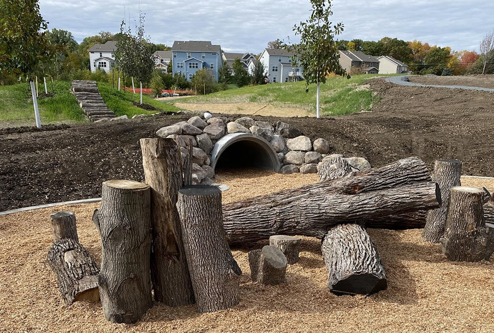 Play area made from natural materials including logs and wood