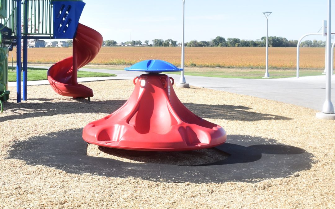 Playground spinner with a safety ImpactMat around it