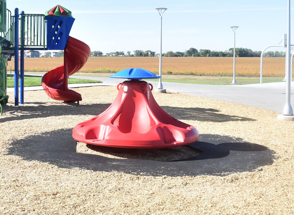Playground spinner with a rubber safety mat