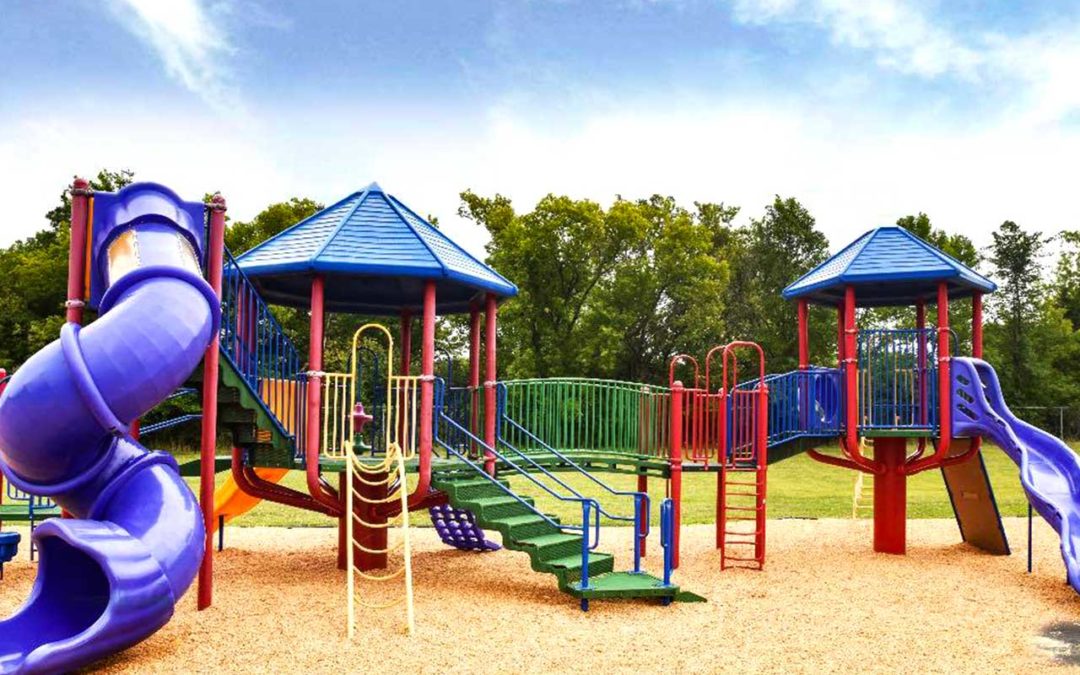 Bright colored and large playground with platforms, slides, and climbing