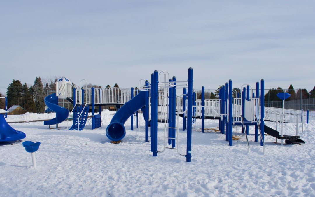 Blue and white playground covered in snow
